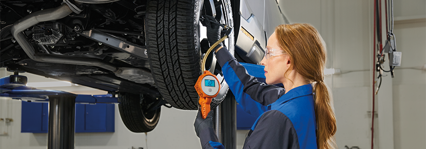 A Subaru technician checking tire pressure. | Victory Subaru in Somerset NJ